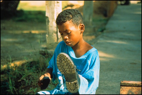 Shoeshine Boy making his money working downtown on main street